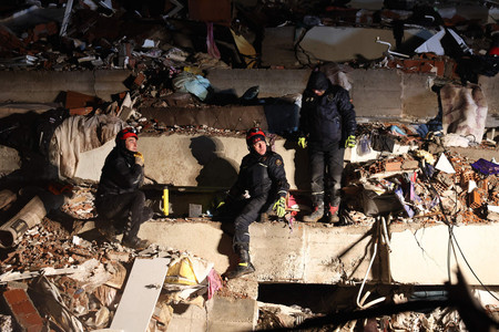 ７日、トルコ南部カフラマンマラシュ県の倒壊した建物で、救助活動を続ける救急隊（ＡＦＰ時事）