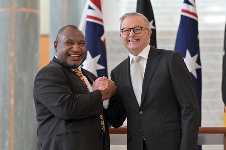 ８日、オーストラリアの首都キャンベラで、握手するアルバニージー首相（右）とパプアニューギニアのマラペ首相（ＥＰＡ時事）