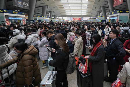 中国春節（旧正月）の駅で、電車に乗るために列に並ぶ人たち＝１７日、北京（ＡＦＰ時事）