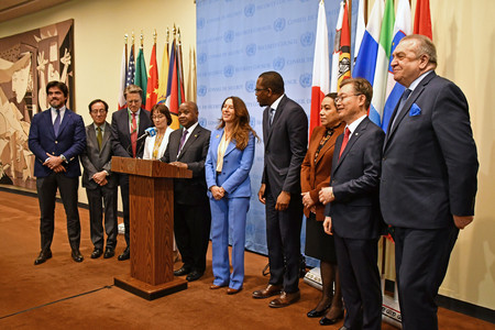 ２５日、米ニューヨークの国連本部で、決議採択を受け共同声明を発表する山崎和之国連大使（左から２人目）ら安保理非常任理事国の大使