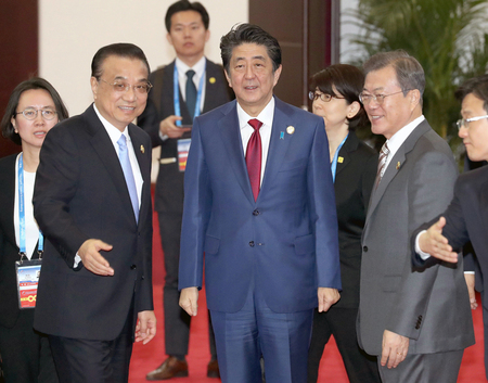 写真撮影に向かう（右から）韓国の文在寅大統領、安倍晋三首相、中国の李克強首相（肩書はいずれも当時）＝２０１９年１２月２４日、中国四川省成都