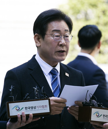 ９日、ソウル中央地裁に到着し取材に応じる韓国最大野党「共に民主党」の李在明代表（ＥＰＡ時事）