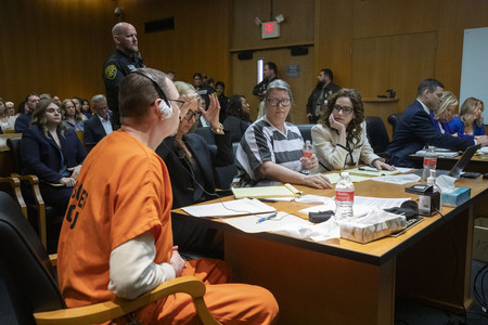 ９日、米ミシガン州デトロイト近郊の裁判所に出廷した父ジェームズ・クランブリー（手前左）と母ジェニファー（同左から３人目）両被告（ＡＦＰ時事）