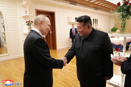 １９日未明、平壌で握手するロシアのプーチン大統領（左）と北朝鮮の金正恩朝鮮労働党総書記＝朝鮮中央通信提供（ＡＦＰ時事）