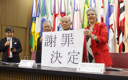 ブラジル政府による日本移民への謝罪後に、撮影に応じるアルメイダ恩赦委員長（右）と日系人代表ら＝２５日、ブラジリア